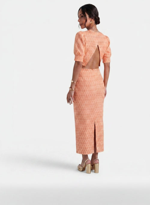 Back pose of the model wearing Conjunto Mujer 2 Piezas Top Corto y Falda con Abertura